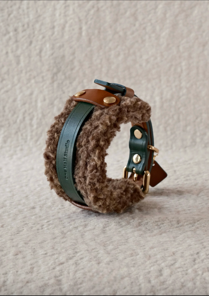 Stack of handmade Merino wool leather dog collars, featuring cozy and stylish designs in neutral and pastel tones.